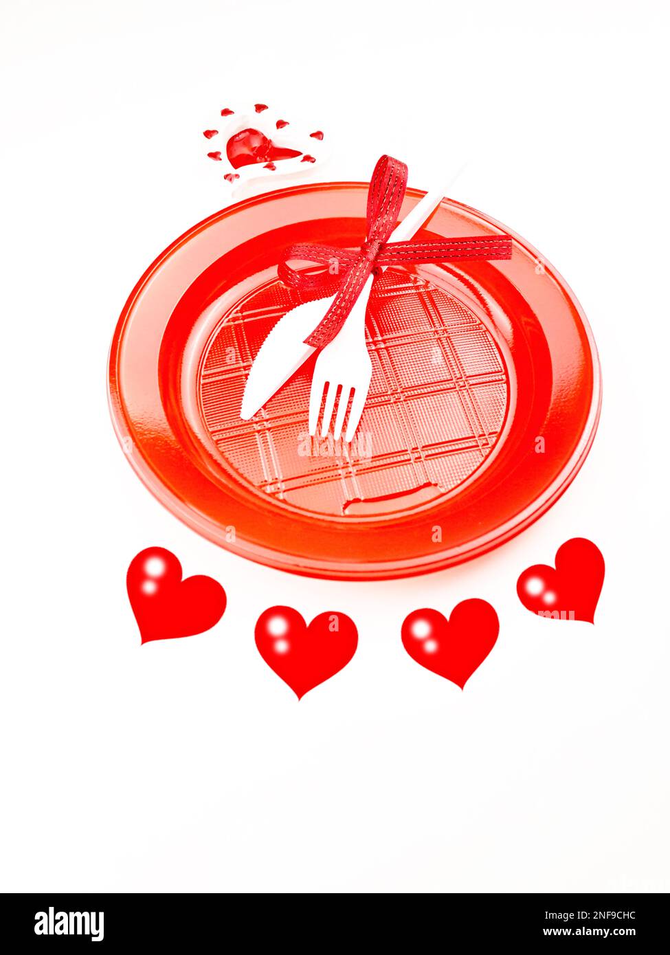 Holiday Menu For Valentine's Day. Plastic plate and cutlery. Outline hearts on a white background. Stock Photo