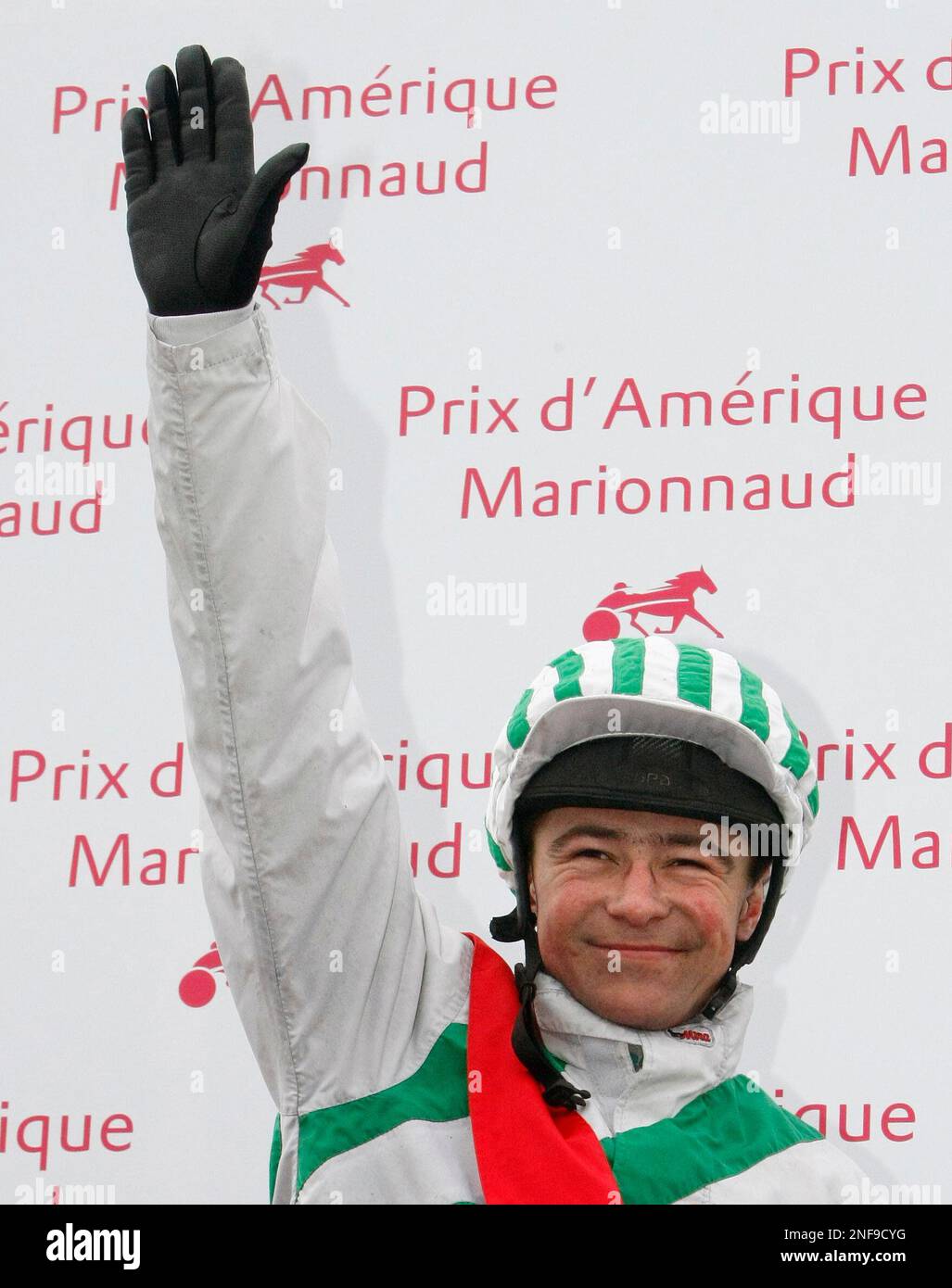 Jockey Franck Nivard reacts on the podium after winning on horse