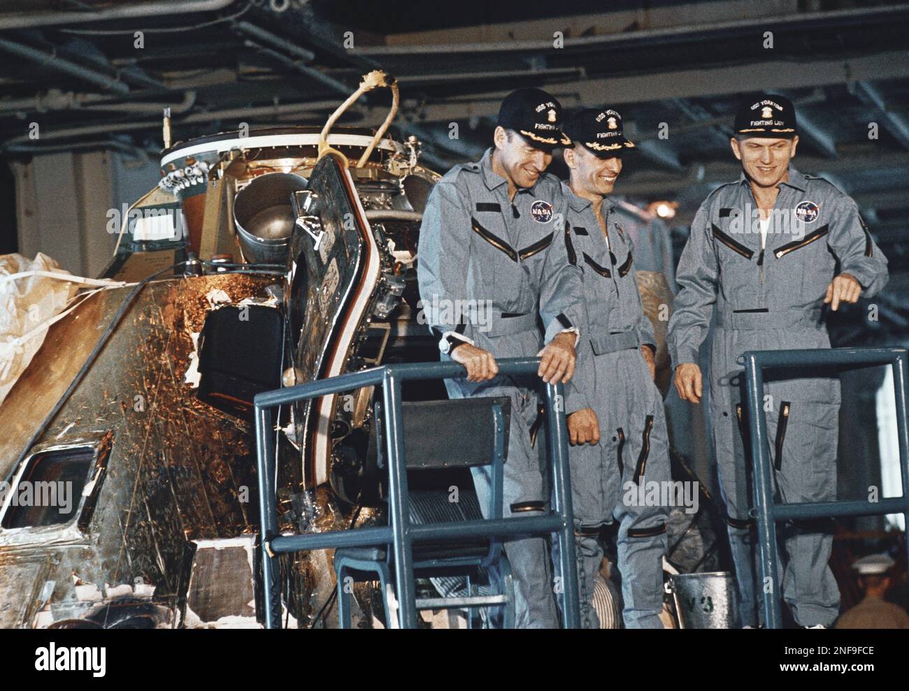 Apollo 8 astronauts wearing NASA uniforms and Navy caps inspect the ...