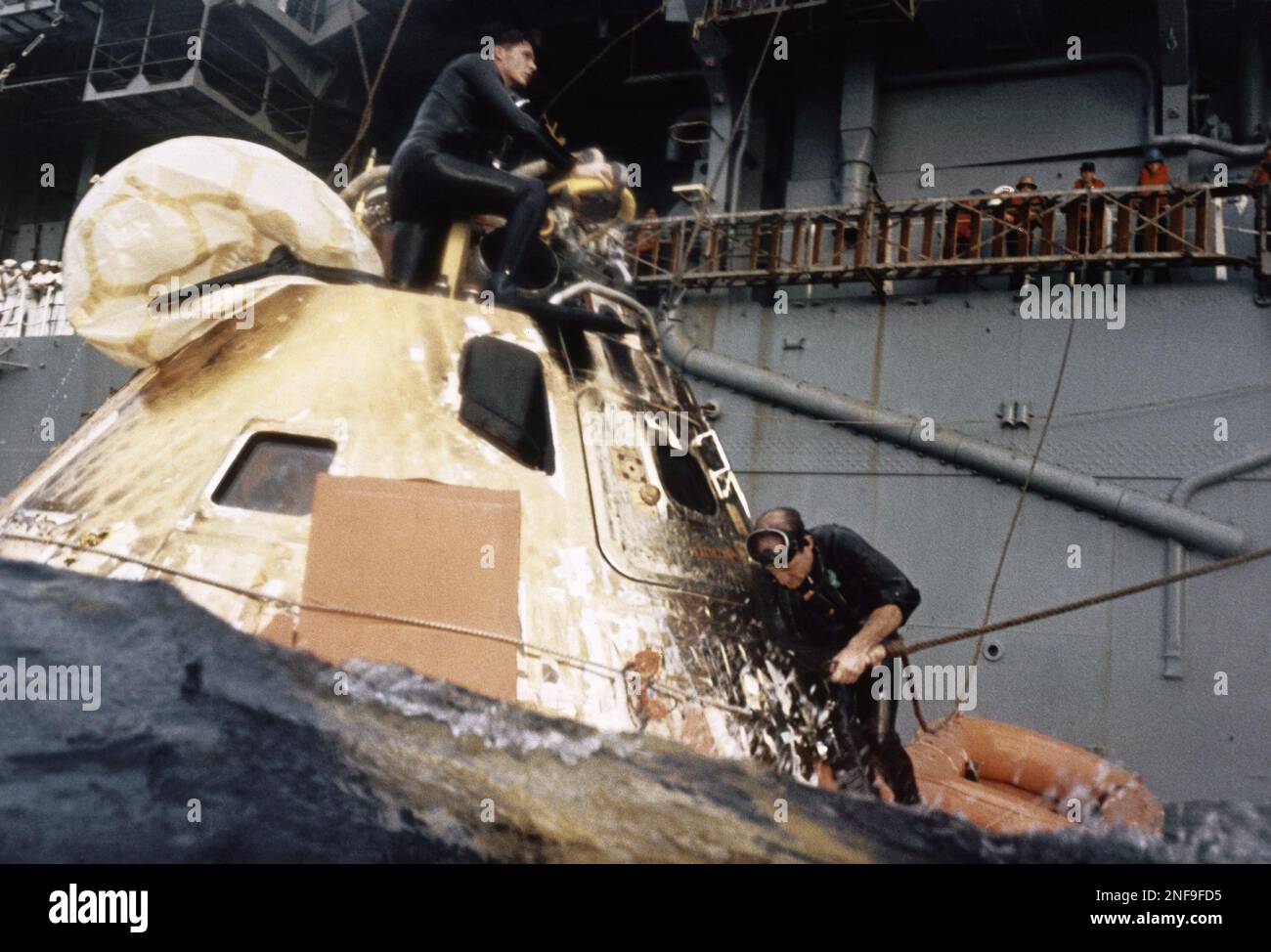 Apollo 8 astronauts wearing NASA uniforms and Navy caps inspect the ...