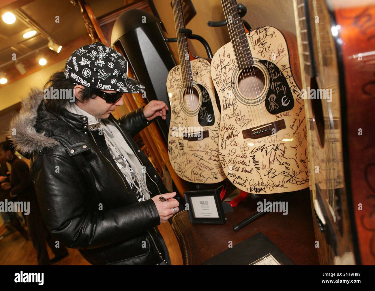 Musician Kevin Rudolph signs a guitar at the Gibson Guitar Lounge ...