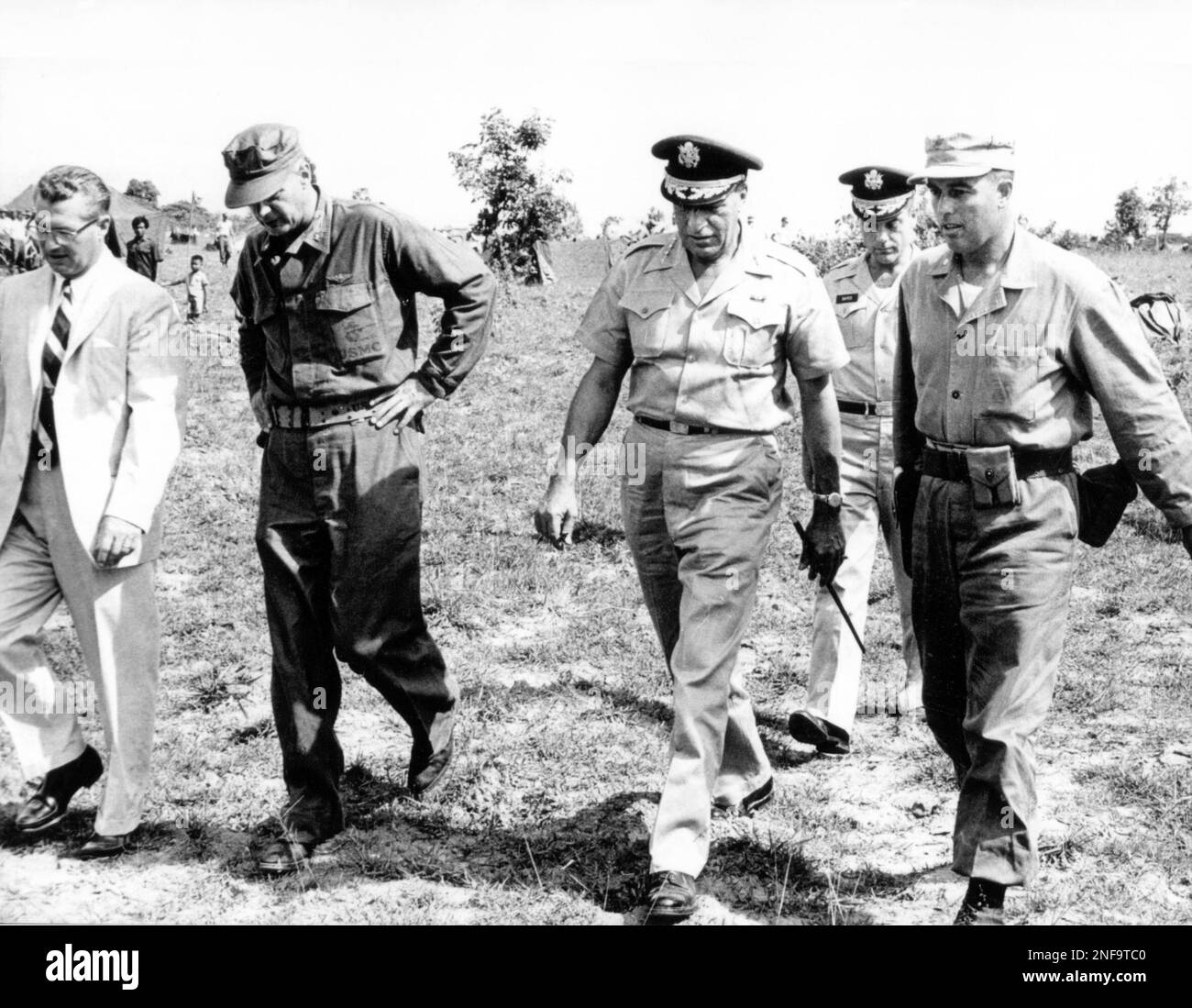 Gen. Paul D. Harkins, U.S. top military commander in Southeast Asia, makes  inspection trip of marine post at Udorn, May 19, 1962. Civilian in picture  is U.S. ambassador to Laos, K.T. Young. (