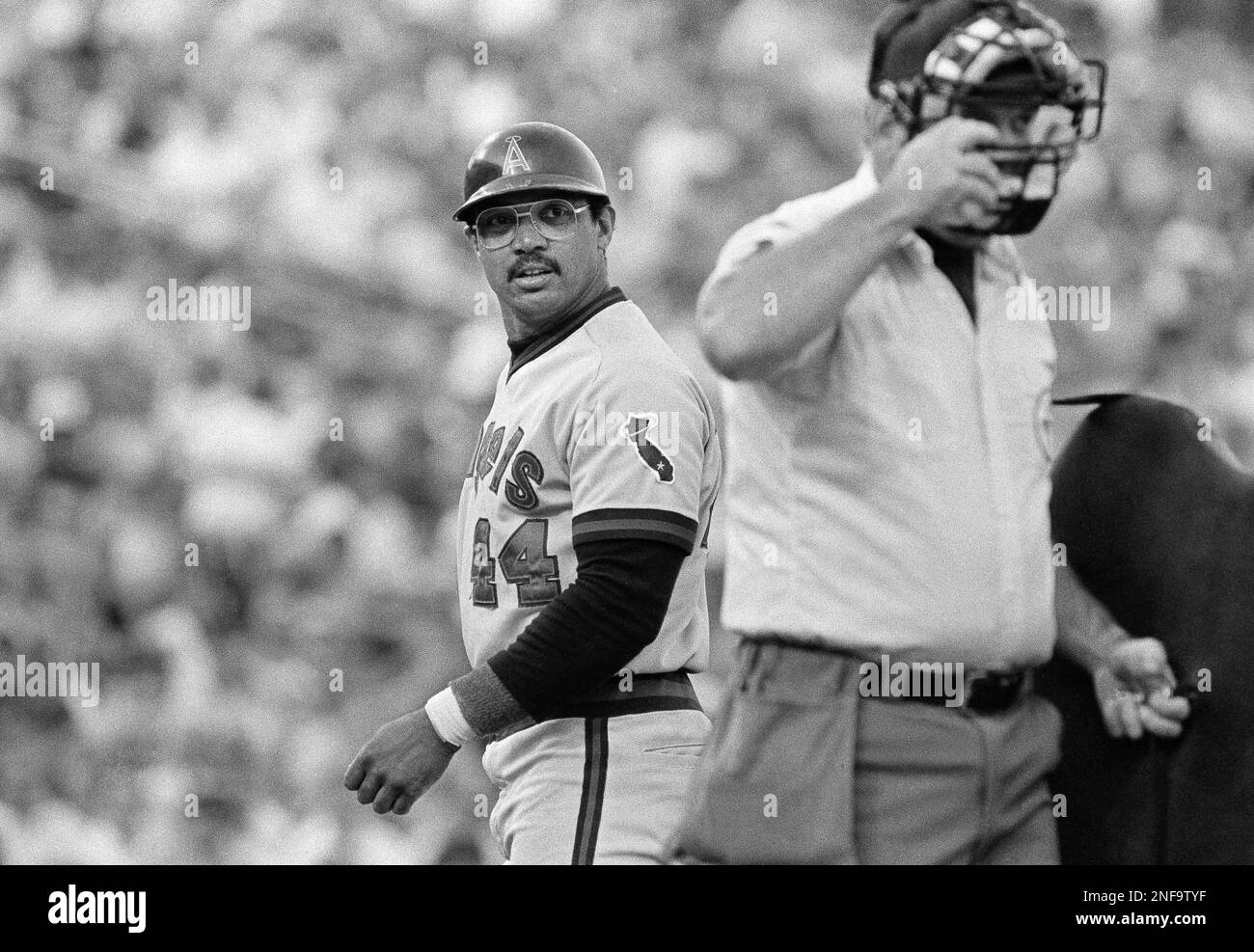 Reggie Jackson (44) of the California Angels looks over his shoulder as he questions the strike three call by home plate umpire Dale Ford, at Arlington, Texas, June 20, 1983. Jackson struck out his first two at bats against the Texas Rangers. (AP Photo/David Breslauer) Stock Photo
