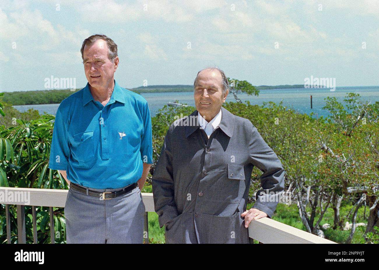 President George Bush gives French President Francois Mitterrand a guided  tour of the Richard Farmer residence, which is the site of a news  conference following their bilateral meeting at Key Largo, Fla.,