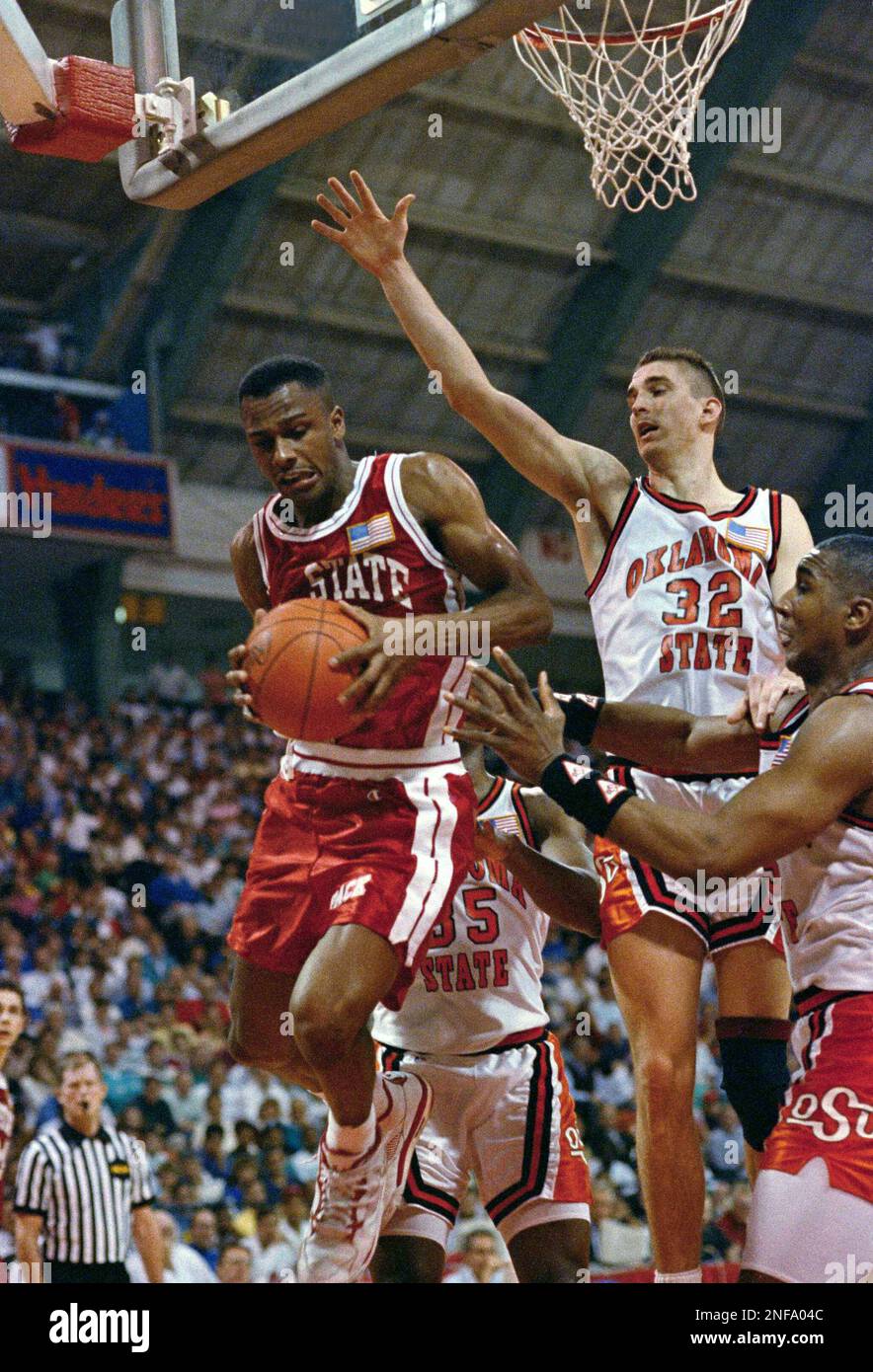 North Carolina State guard Rodney Monroe, left, pulls down a 