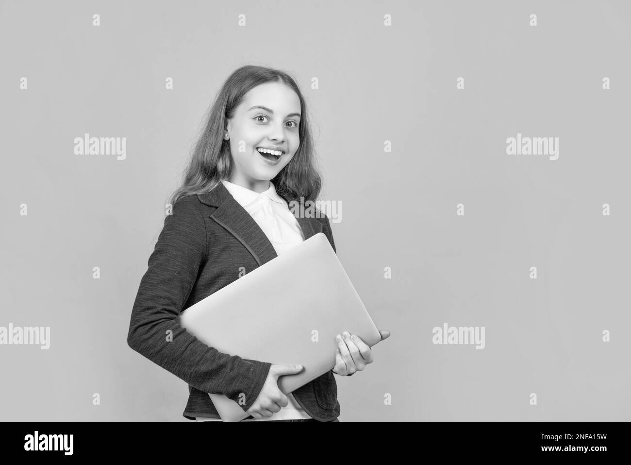 happy child with laptop on green background Stock Photo - Alamy