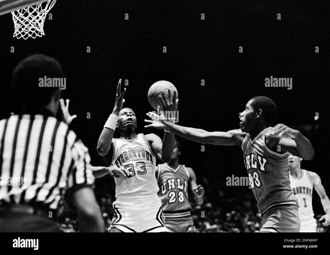 Georgetown University's Pat Ewing, left, has the ball