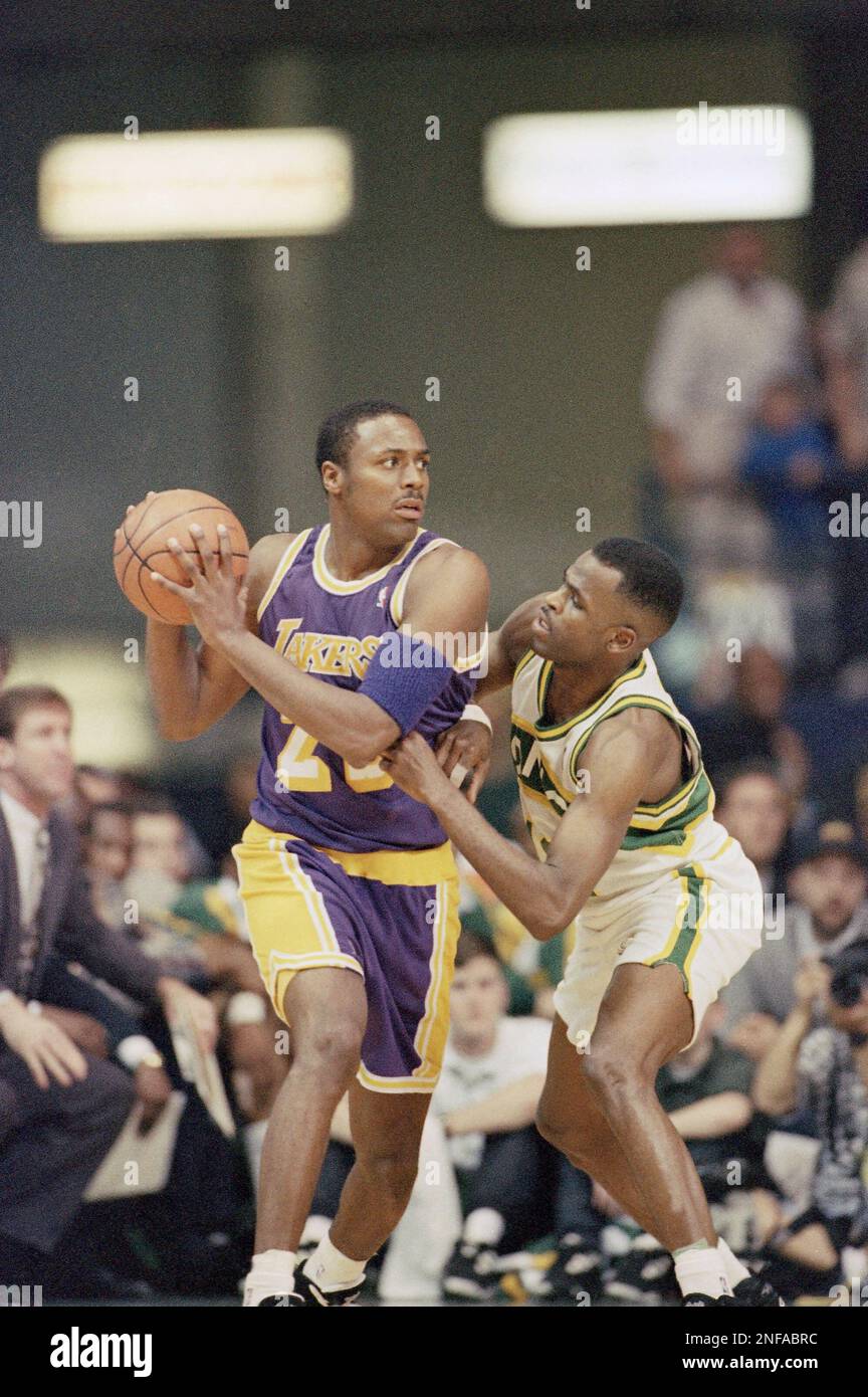 Los Angeles Lakers' Cedric Ceballos dunks over Washington Bullets' Jim  McIlvaine during the first half at