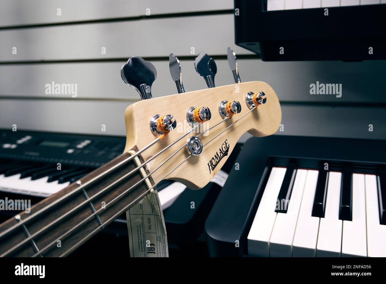Bass guitar head against the background of musical digital synthesizers Stock Photo