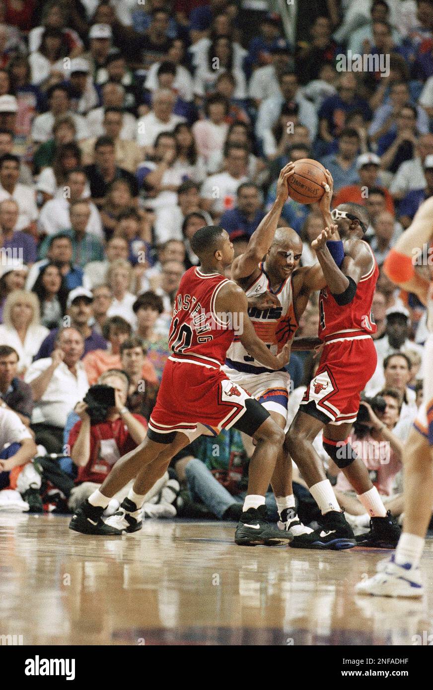 The Phoenix Suns Charles Barkley, center, muscles for position