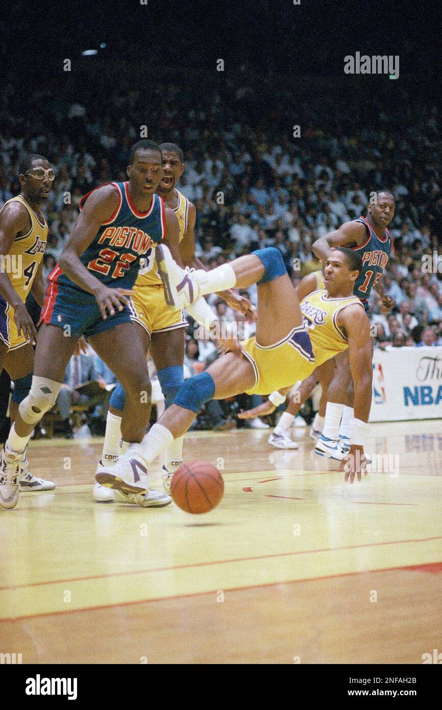 Los Angeles Lakers' Mychal Thompson falls to the court as teammate Magic  Johnson screams his displeasure at the Forum in Inglewood, June 9, 1988,  and Detroit's John Salley moves in to take