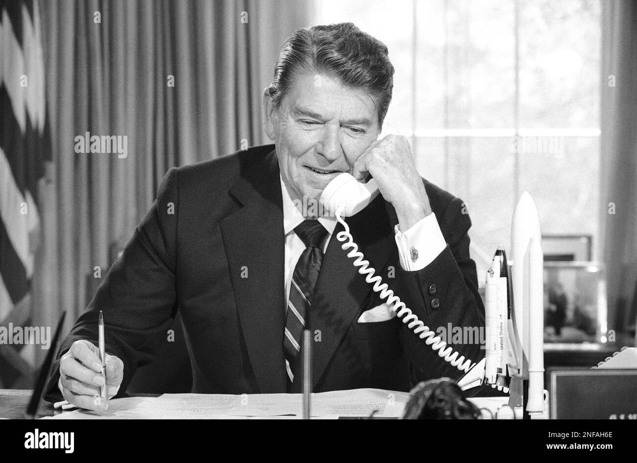 President Ronald Reagan speaks by radio-phone from the Oval Office of ...