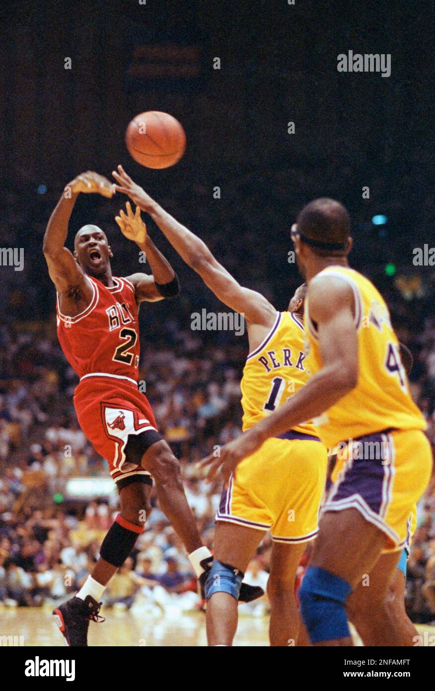 Chicago Bulls' Michael Jordan (left) shoots during third