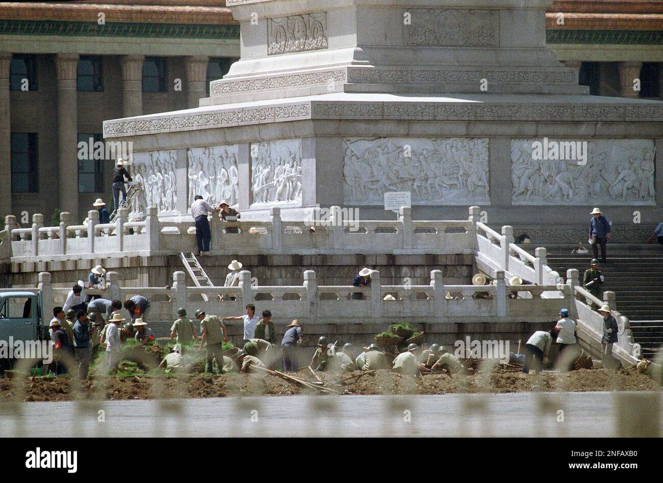 beijing-city-workers-scrub-the-martyr-s-monument-at-tiananmen-square-in