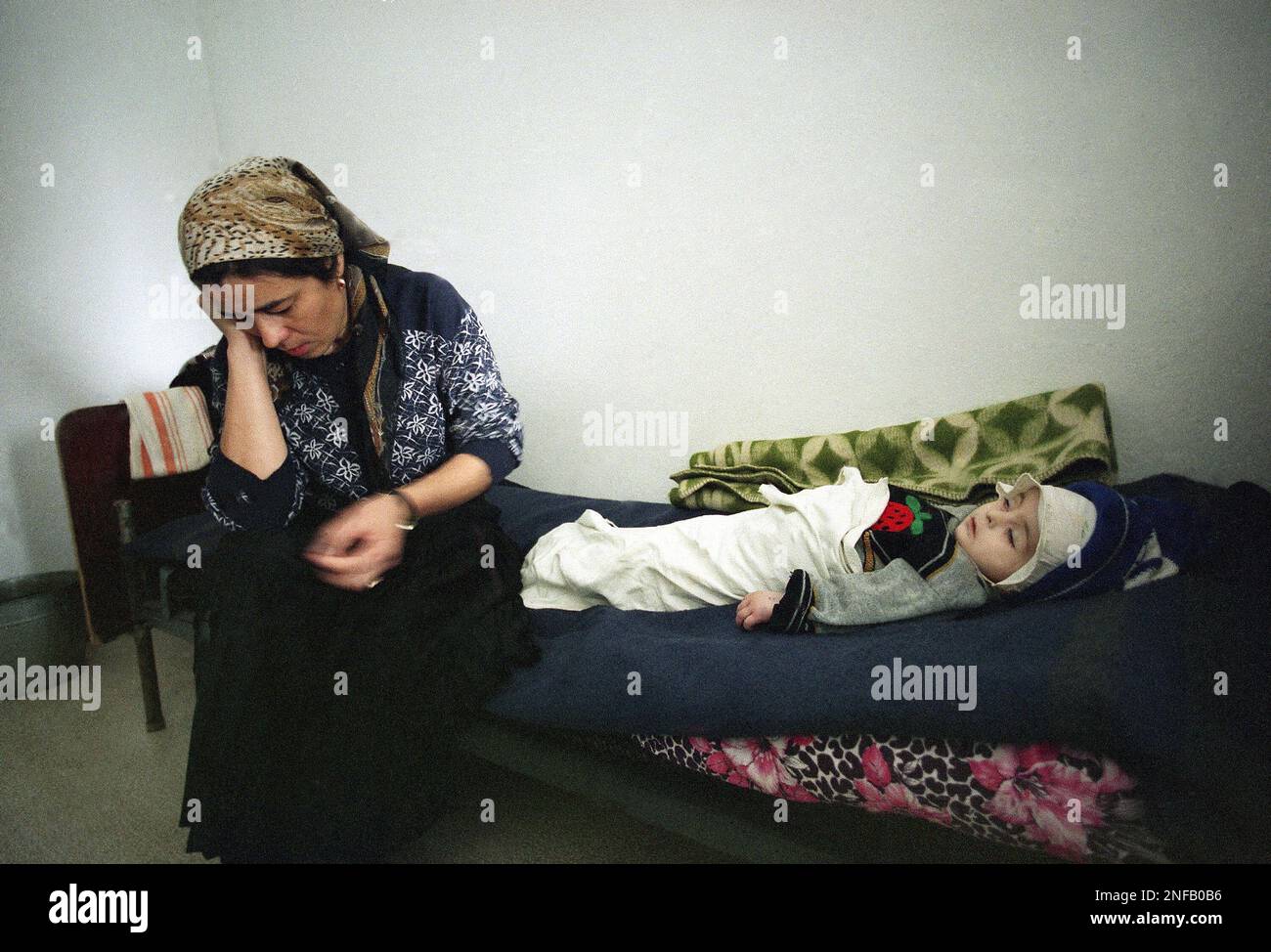 a-chechen-woman-sits-by-her-wounded-daughters-side-on-a-bed-in-a-starye-atagy-hospital-15-miles-south-of-grozny-jan-6-1995-the-child-was-wounded-in-a-bomb-attack-by-russian-warplanes-on-grozny-yesterday-despite-president-boris-yeltsins-promise-to-call-a-bombing-halt-in-the-chechen-campaign-russian-warplanes-continue-to-drop-their-payloads-on-the-chechen-capital-ap-photomindaugas-kulbis-2NFB0B6.jpg