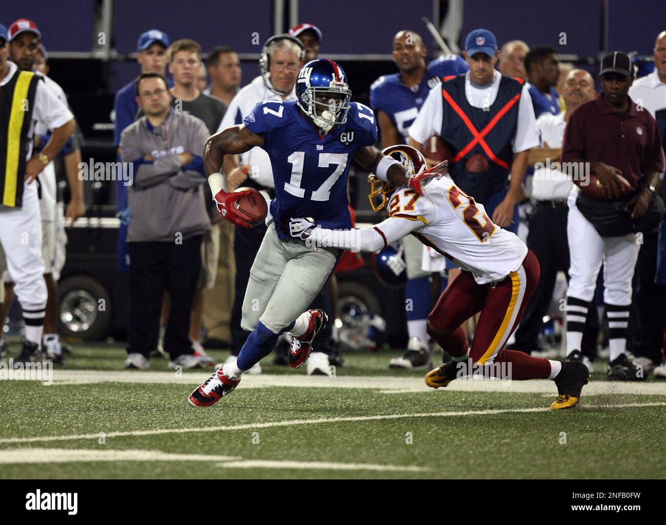 New York Giants Plaxico Burress catches a 52 yard pass over New England  Patriots (27) Ellis Hobbs III in the first quarter at Giants Stadium in  East Rutherford, New Jersey on December