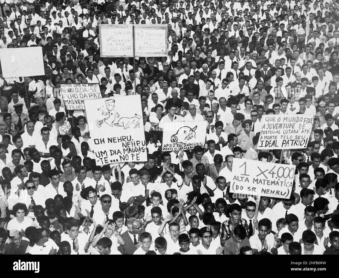 Europeans and Africans, some carrying signs, crowd for a mass rally ...