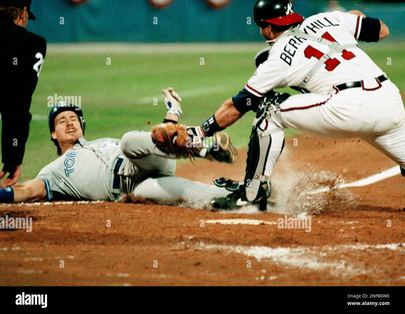 Toronto Blue Jay Pat Borders is tagged out at the plate in the fourth  inning of Game 6 of the World Series at Atlanta by Atlanta Braves Damon  Berryhill on a throw