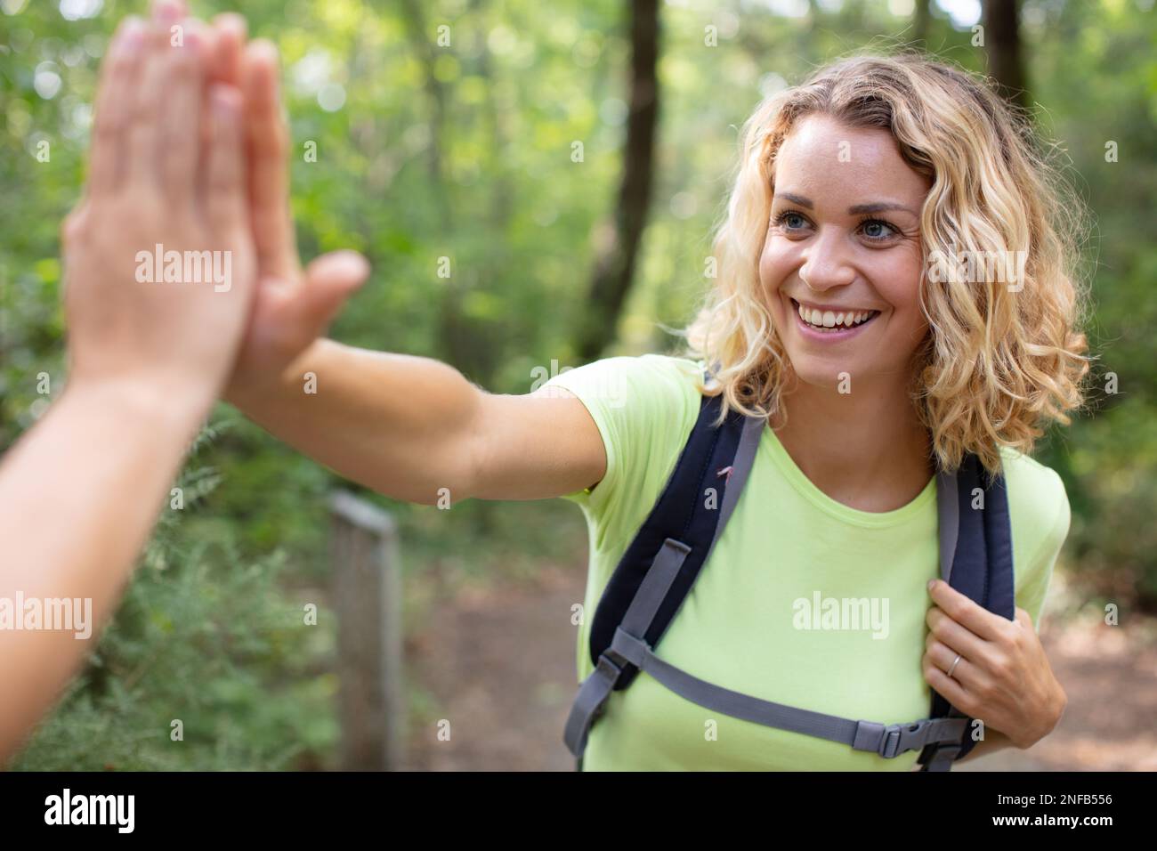 two woman gave each other a high five Stock Photo - Alamy