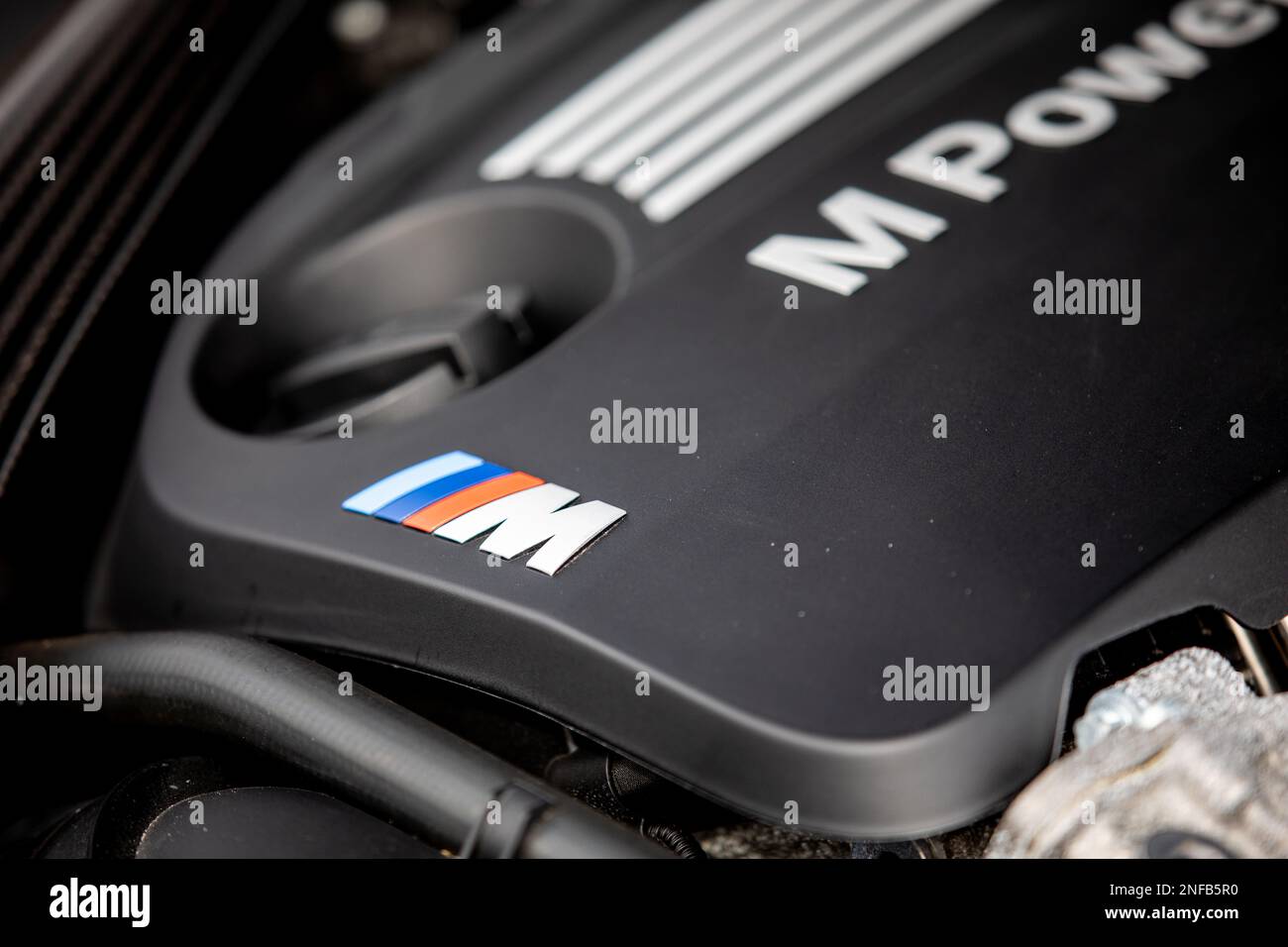 A black and white BMW engine cover featuring exposed wiring and