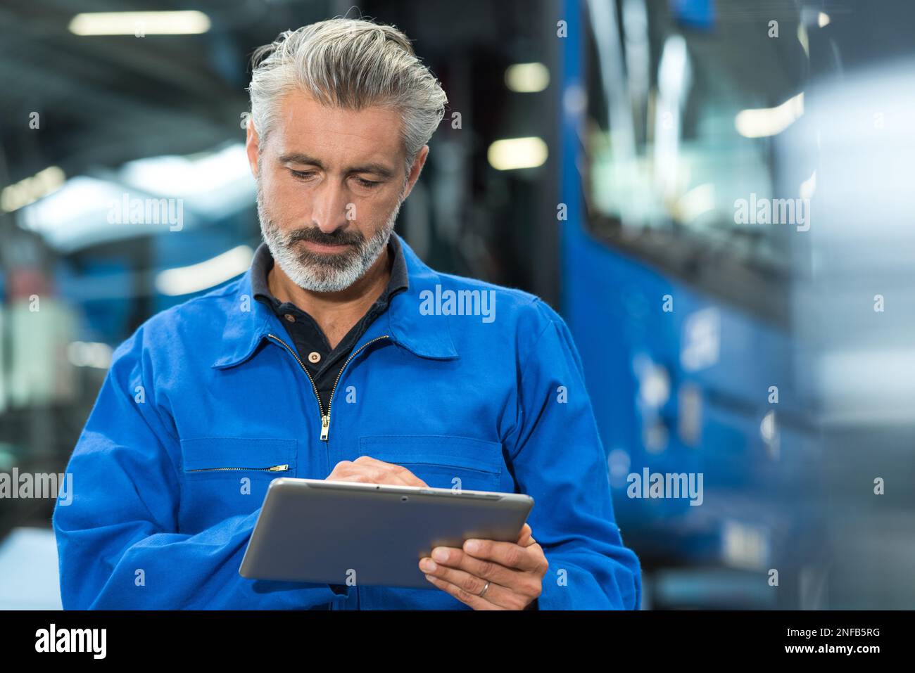 mechanic working with digital tablet Stock Photo