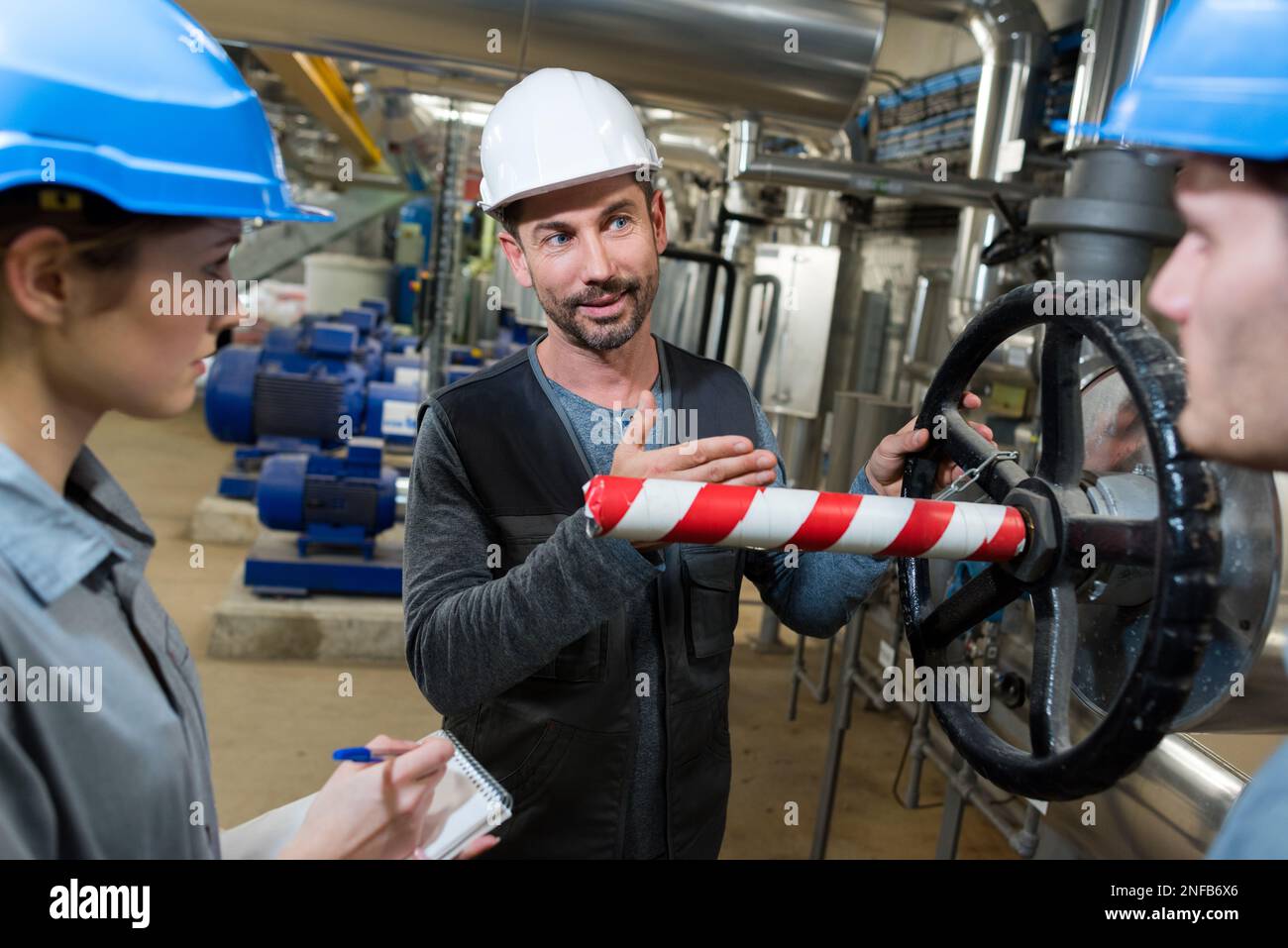 electrical engineer with apprentices working at control room Stock Photo