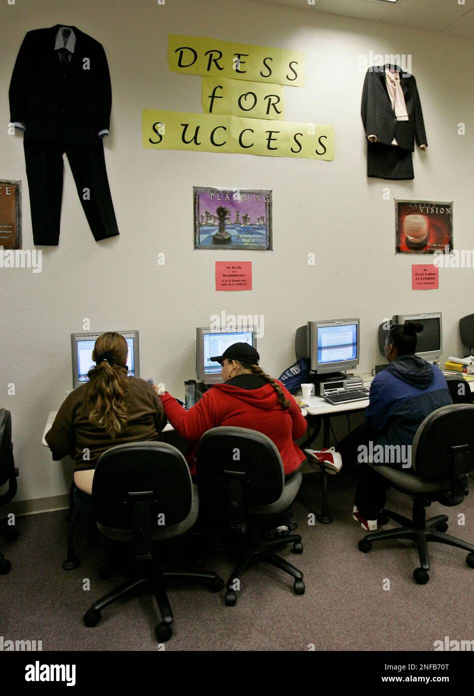 Three people look for a new job at JobTrain, a job training facility in
