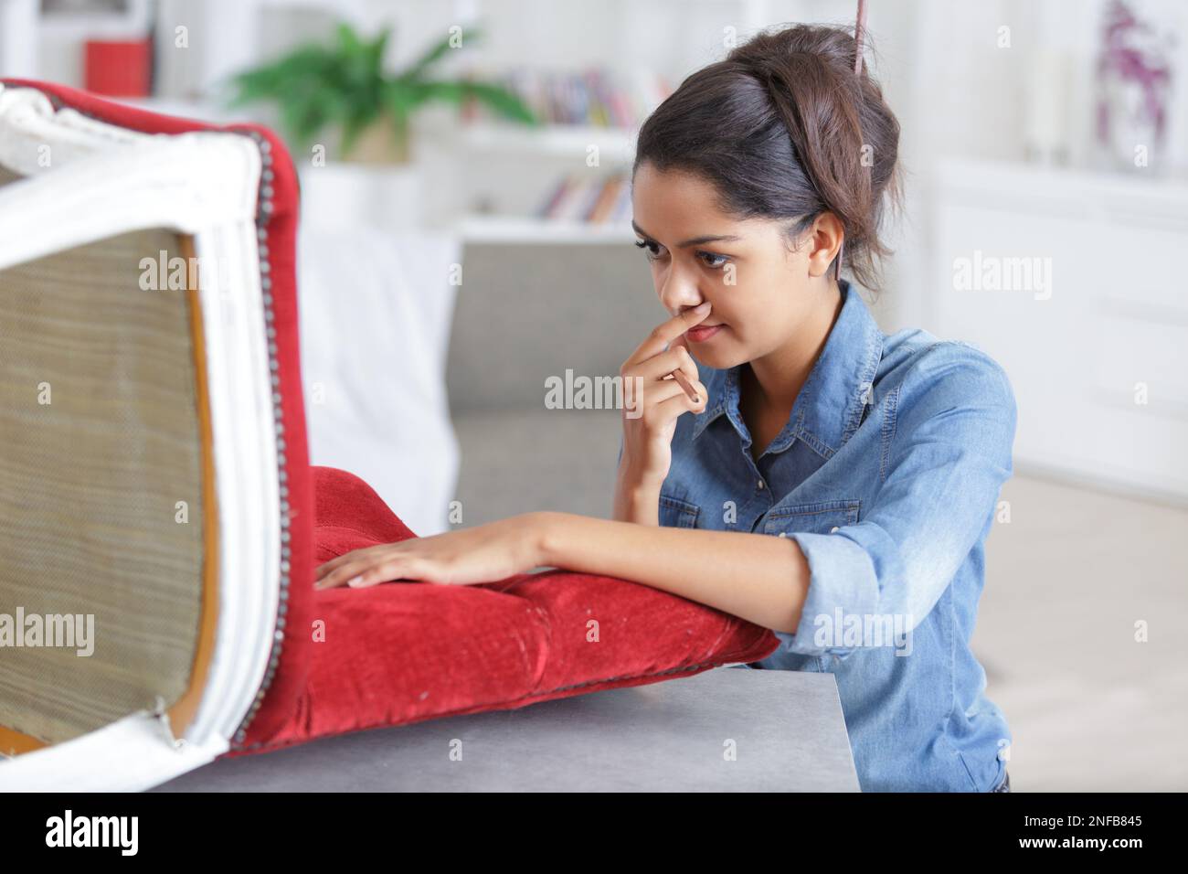a woman fixing a chair Stock Photo Alamy