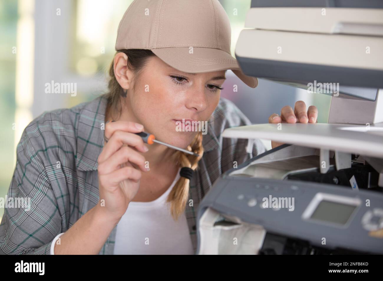 woman fixing a photocopier using a screwdriver Stock Photo Alamy