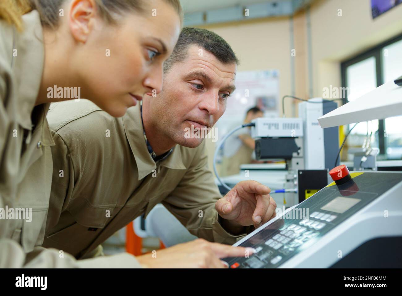 two workers checking industrial machinery Stock Photo - Alamy
