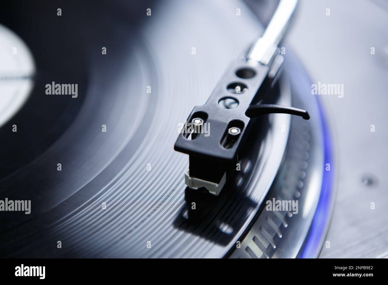 Turntables needle on vinyl record. Tone arm with professional spherical