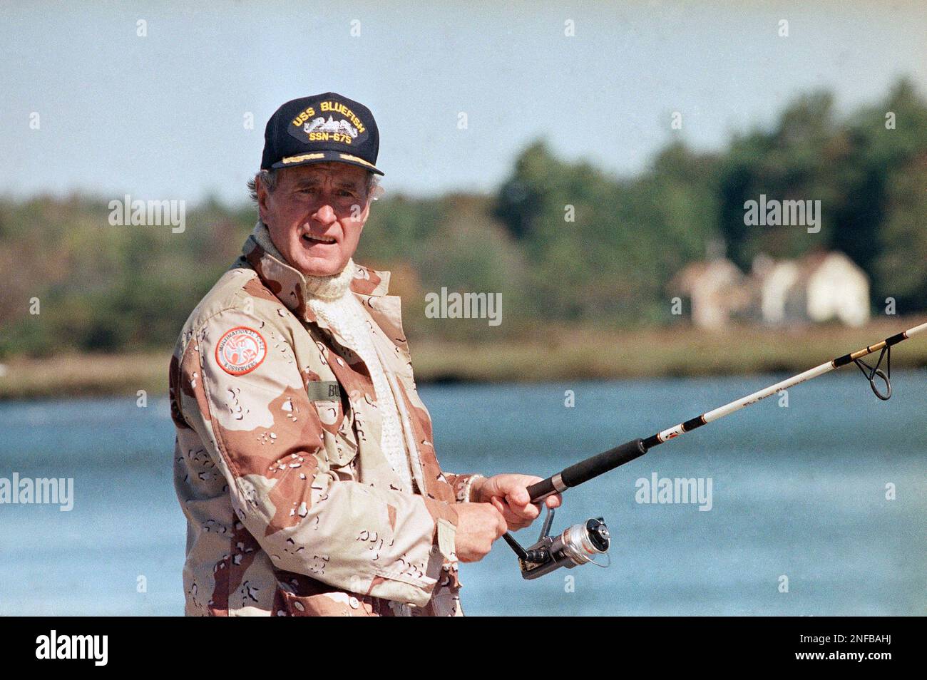 President George Bush casts his fishing rod at the mouth of the