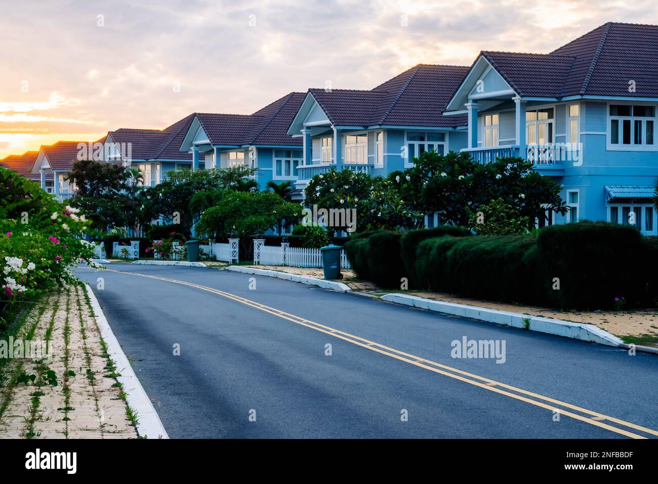 Modern cottages row road sidewalk two story buildings residential