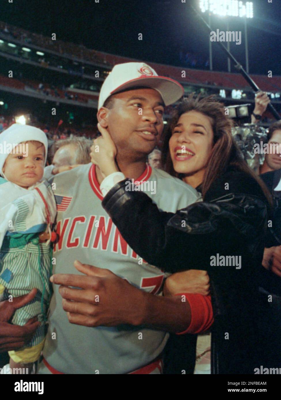 Cincinnati Reds pitcher Jose Rijo hugs his wife, Rosie Rijo, and his son,  Jose Rijo Jr. on the field after the World Series win, Saturday, Oct. 20,  1990, Oakland, Calif. Rijo was