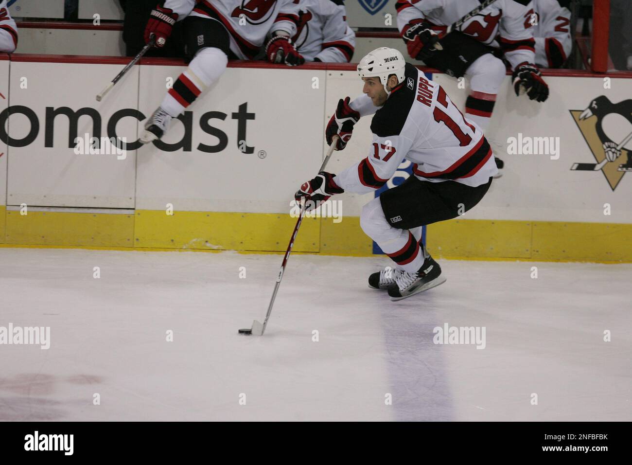 New Jersey Devils' Mike Rupp (17) reaches for the puck in front of