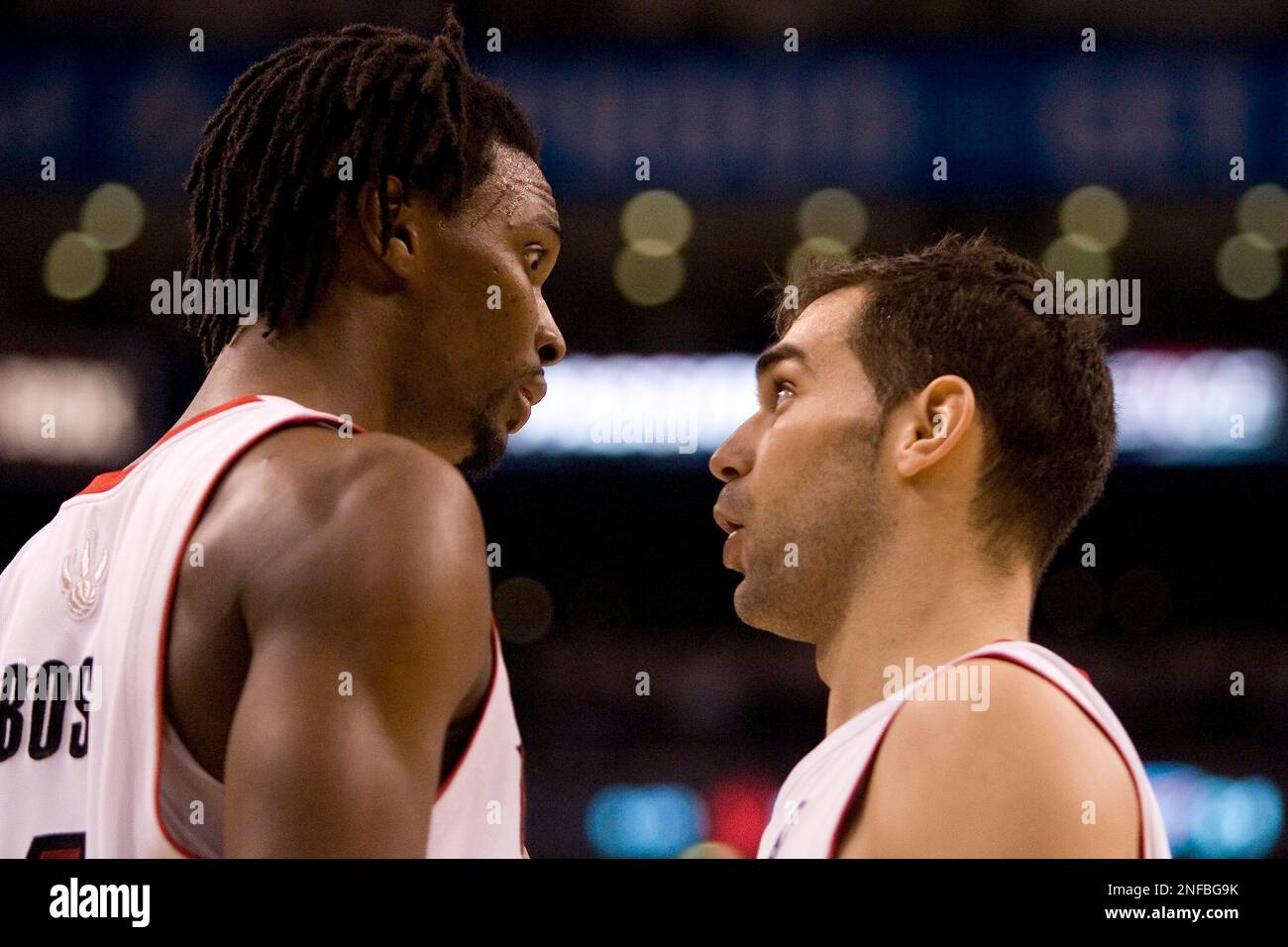 Toronto Raptors' Chris Bosh (left) and Jose Calderon exchange words ...