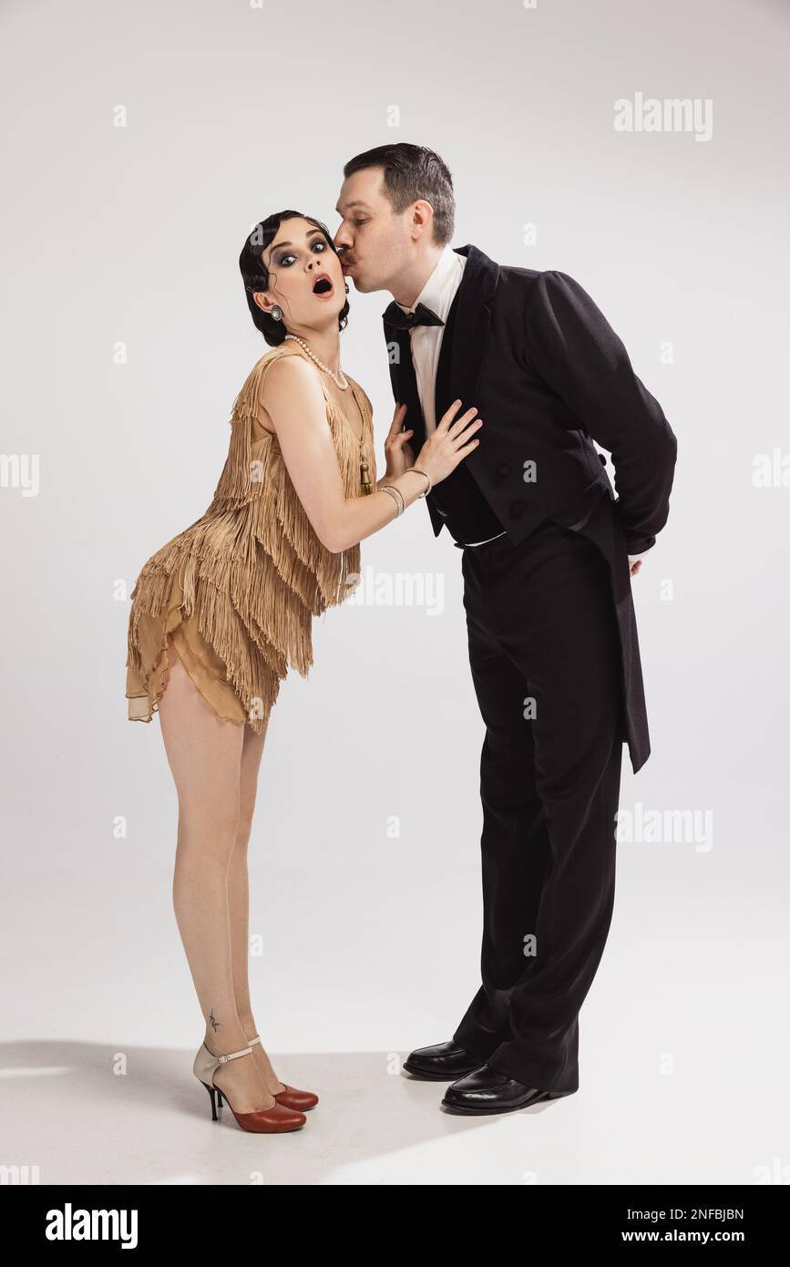 Kiss. Beautiful couple of dancers in vintage stage evening attires dancing  tango. Love and music, vintage fashion. Retro style, Great Gatsby concept  Stock Photo - Alamy