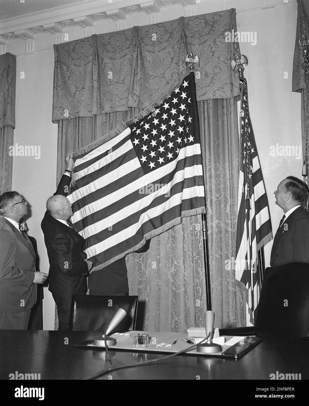 President Dwight Eisenhower is shown at the White House displaying the ...