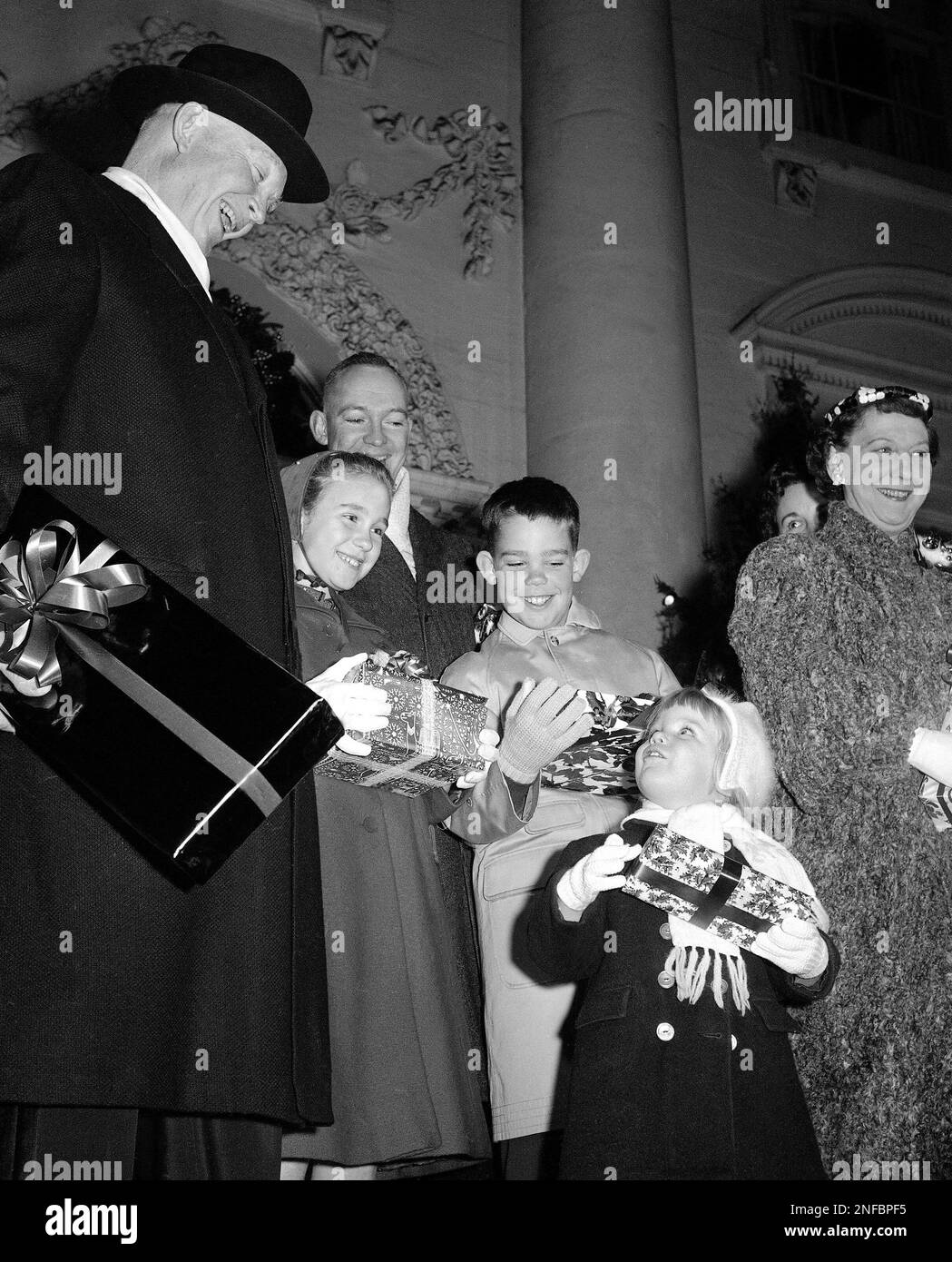 Threeyearold Mary Jean looks up at her laughing grandfather as