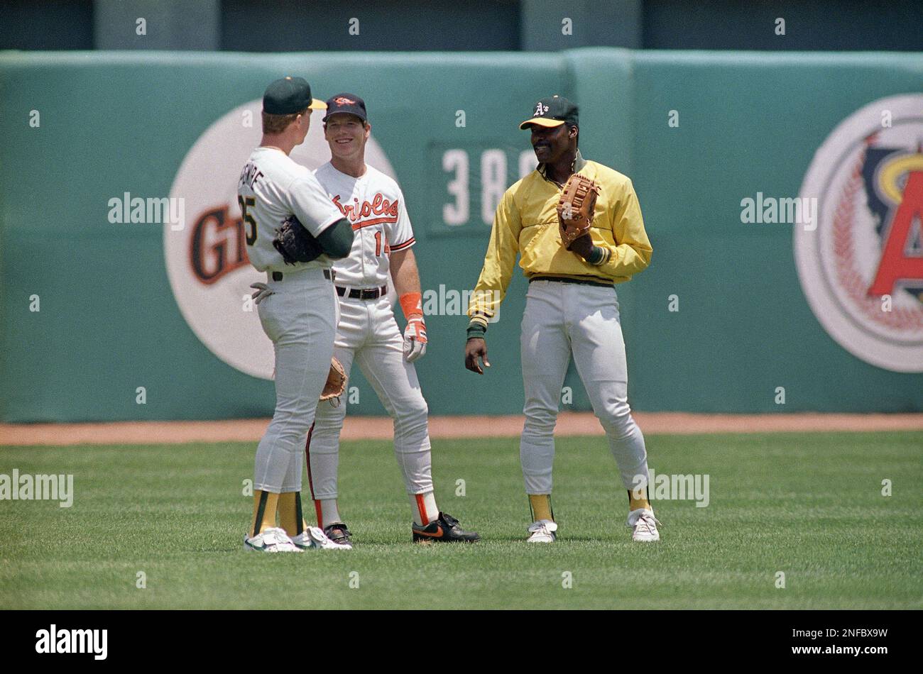 Mark McGwire, left, of Oakland and teammate Dave Stewart, right, confer  with All Star teammate Mickey Tettleton of the Baltimore Orioles, on  Monday, July 11, 1989 during an afternoon practice in Anaheim