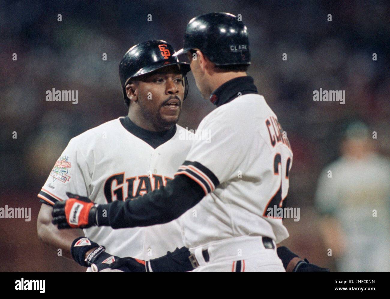 San Francisco Giants' Kevin Mitchell, left, is greeted by
