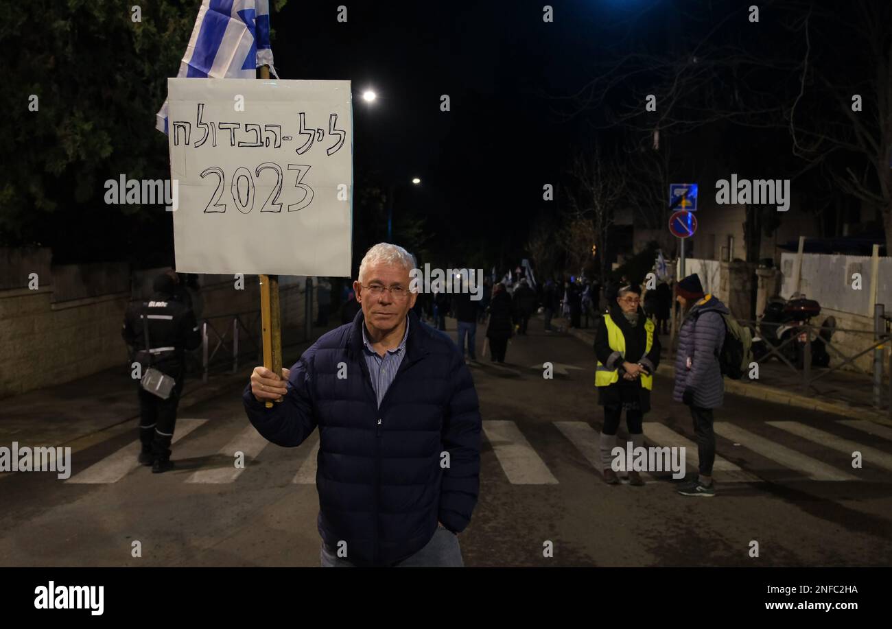 JERUSALEM, ISRAEL - FEBRUARY 16: Anti-government protester holds up a sign which reads 'The Night of Broken Glass 2023' ( Referring to the Nazi Germany's 1938 pogroms against Jews also known as Kristallnacht) during a demonstration against Israel's new government judicial system plan near the private home of prime minister Benjamin Netanyahu on February 16, 2023, in Jerusalem, Israel. Credit: Eddie Gerald/Alamy Live News Stock Photo
