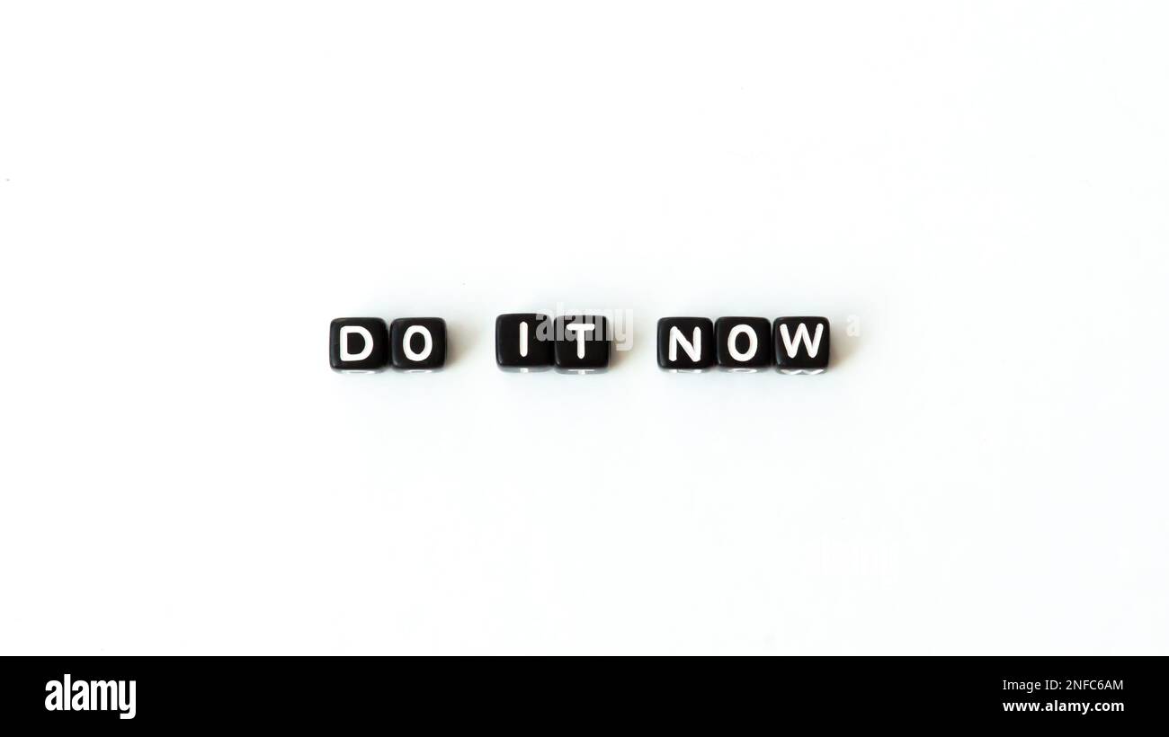 Do it now motivation quote in black letter beads on white background