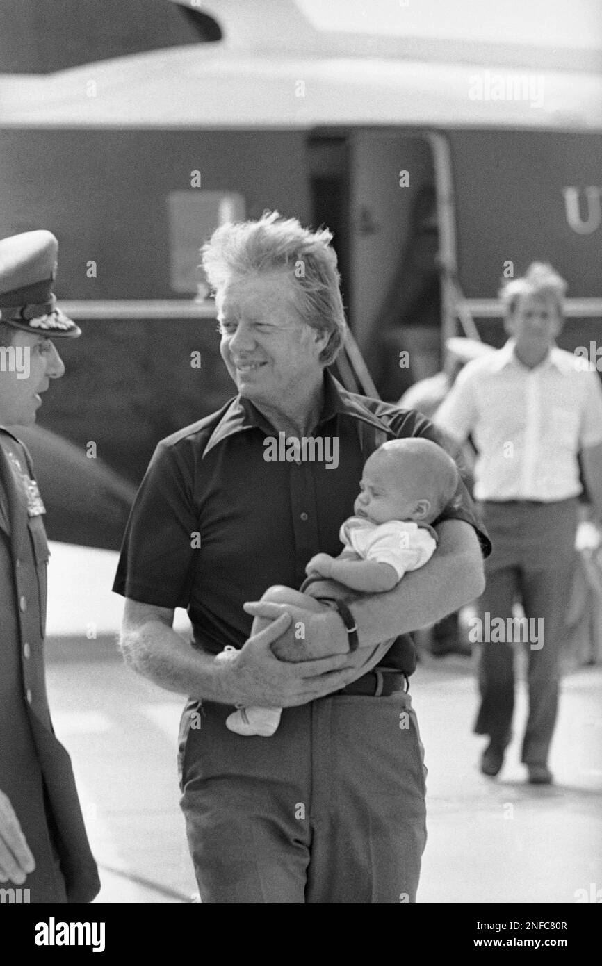 President Jimmy Carter holds grandson James Earl Carter at Warner