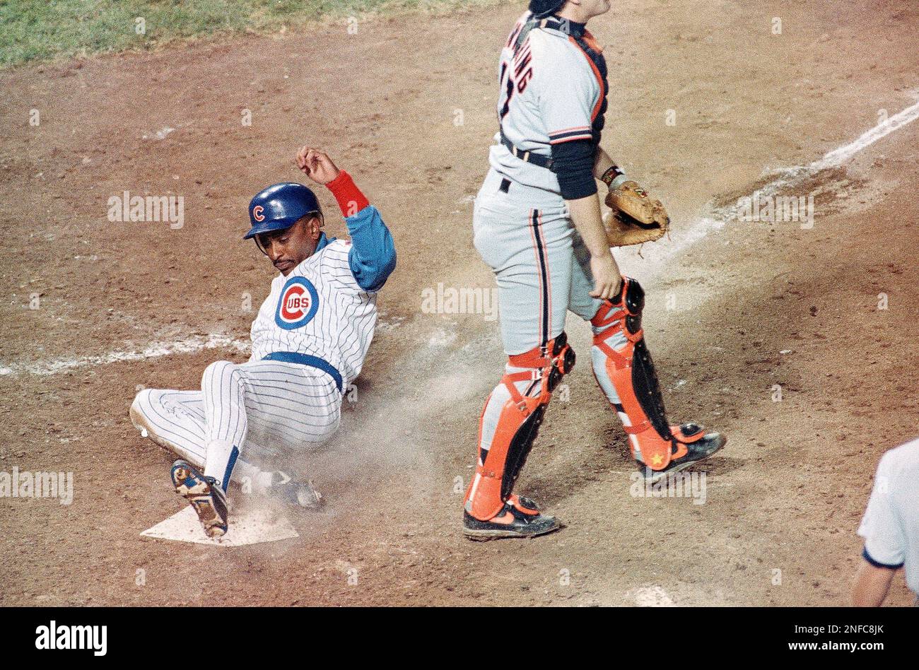 Chicago Cubs Dwight Smith, left, slides home behind San Francisco
