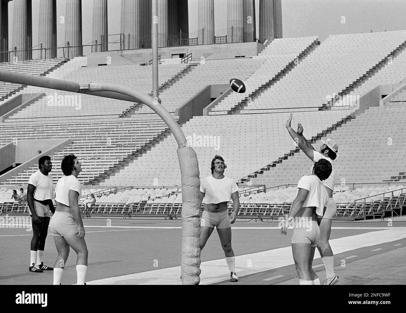 College AllStars play a modified game of volleyball, with a football