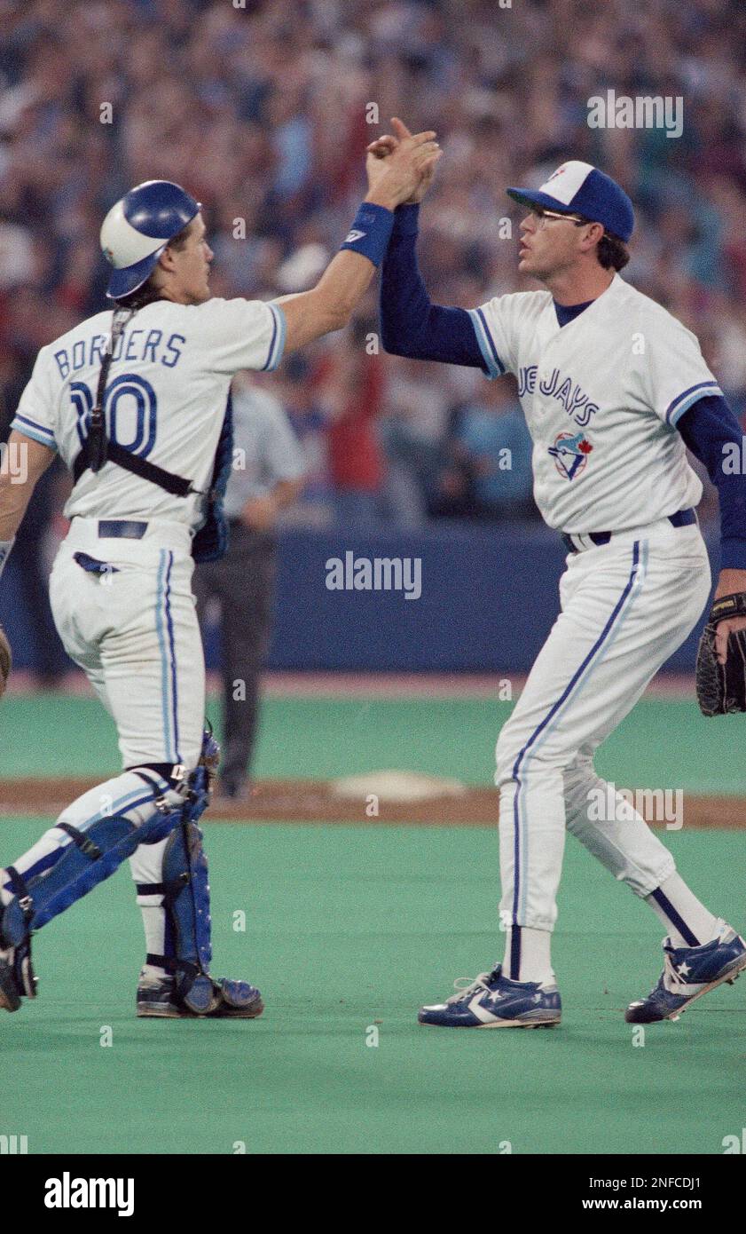 Toronto Blue Jays pitcher Tom Henke is congratulated by catcher Pat Borders  after Henke shut down the Oakland Athletics to give the Jays a 3-1 victory  at the American League playoffs at