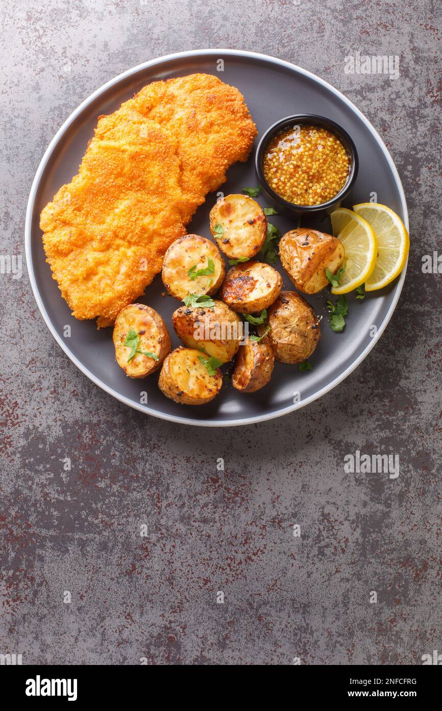 Munchner Schnitzel veal cutlets are brushed with a combination of sweet mustard and horseradish before coated in flour, eggs and breadcrumbs then frie Stock Photo