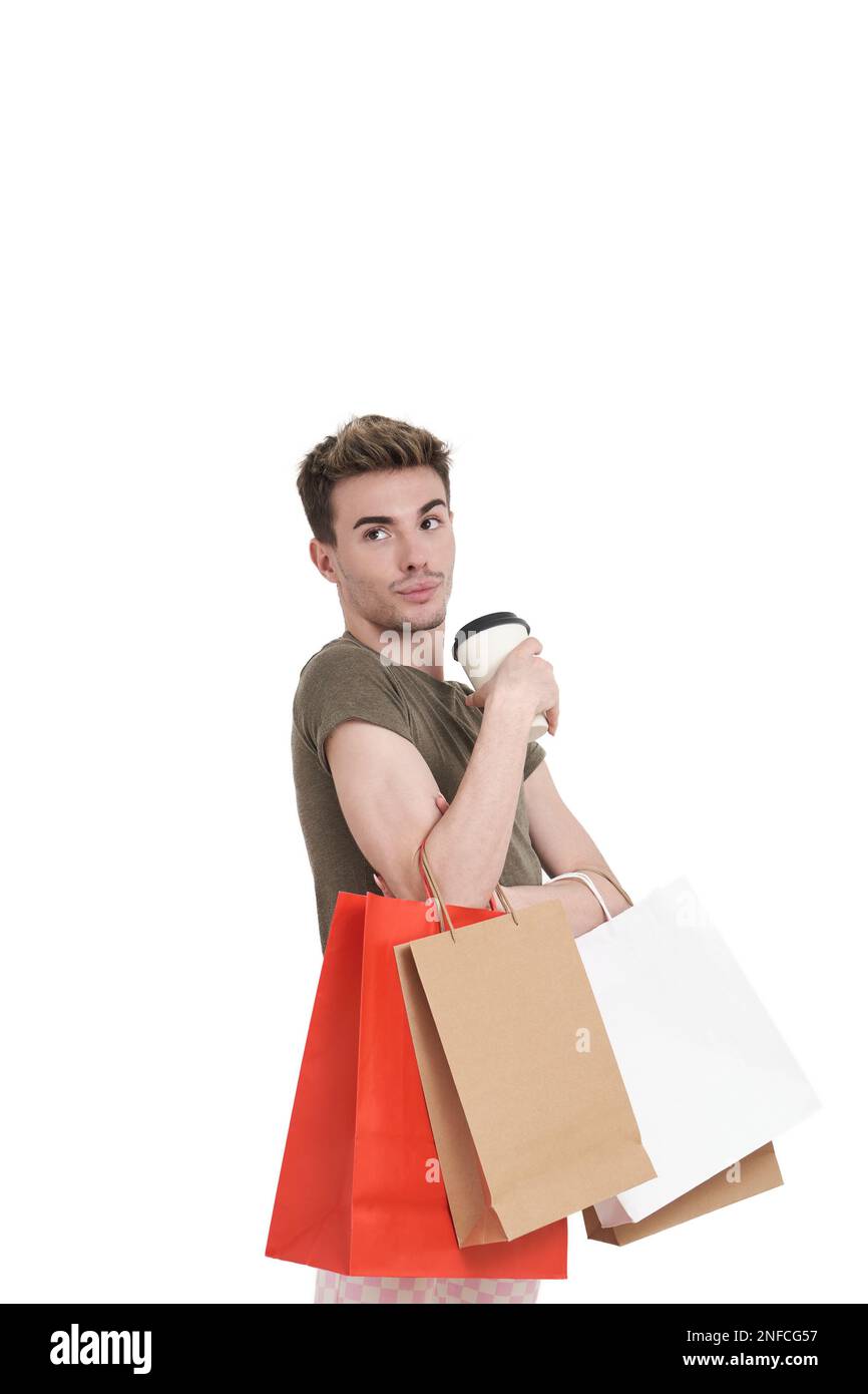 Young caucasian man holding shopping bags and coffee, isolated. Stock Photo