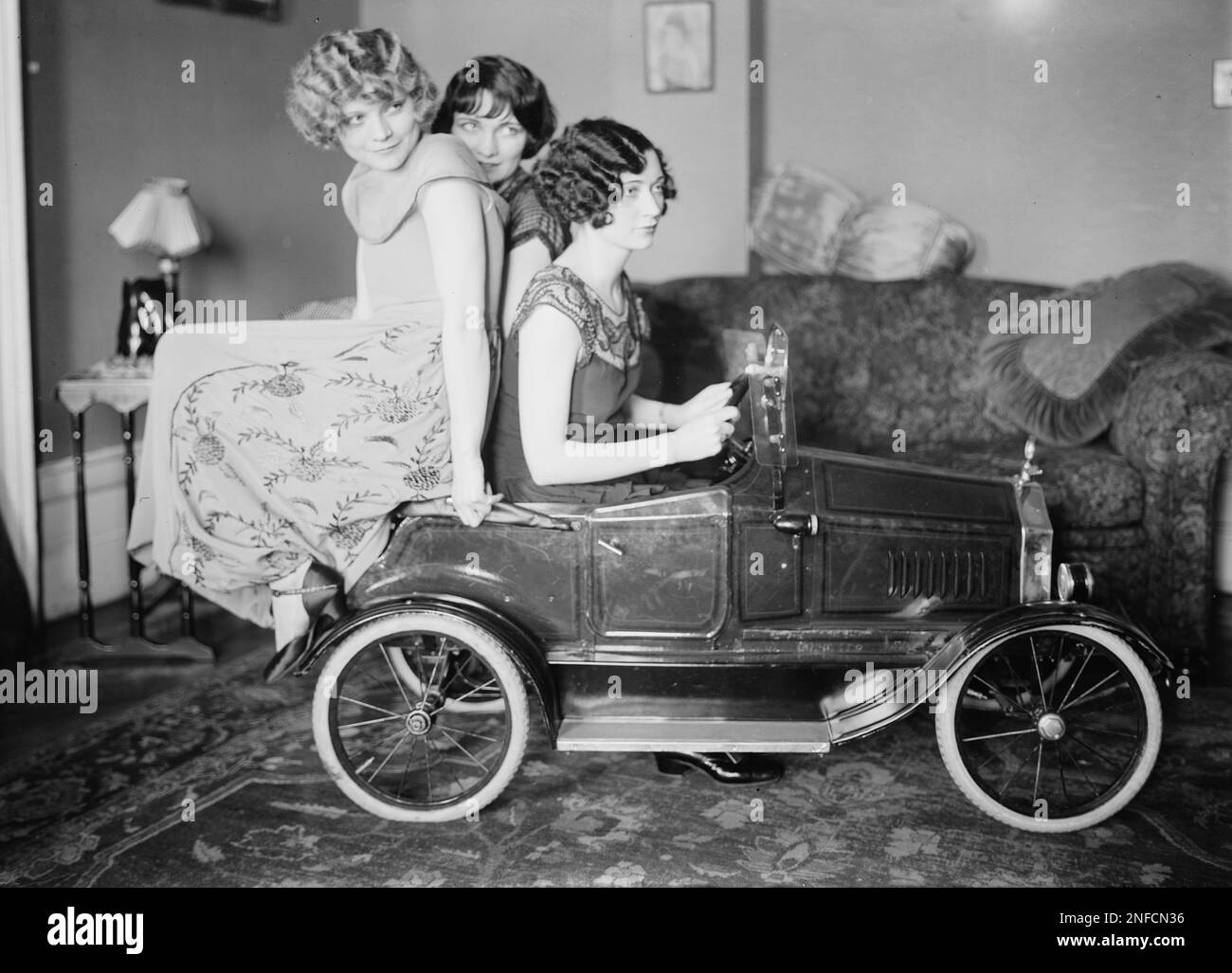 The Brox Sisters, posed with toy car. Left to right- Loryane, Bobbe, Patricia -  c1925 Stock Photo